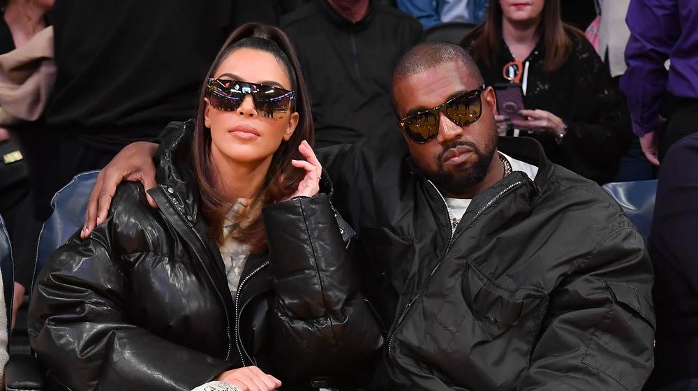 Kanye West and Kim Kardashian at a basketball game