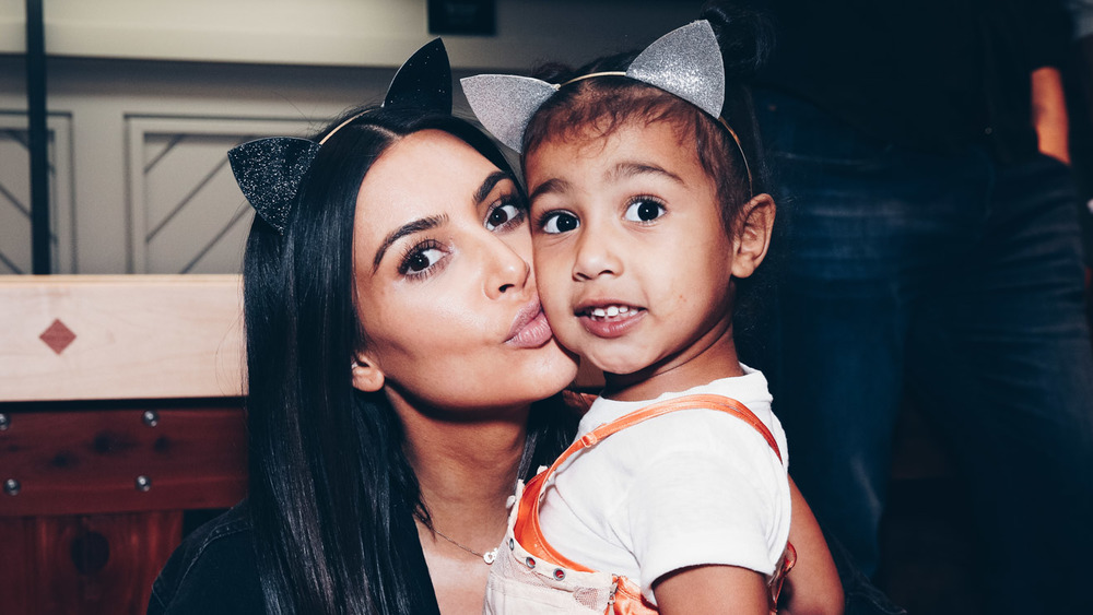 Kim Kardashian giving North West a smooch