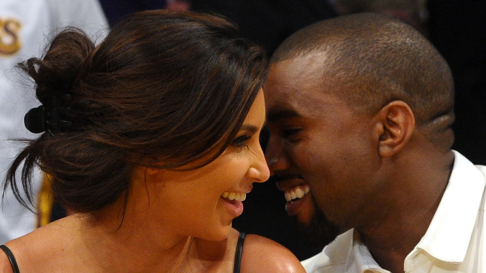 Kanye West and Kim Kardashian smiling at each other