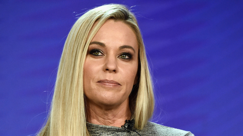 Kate Gosselin weasrs a gray dress. 