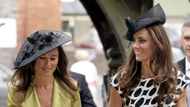 Pippa and Kate Middleton wearing black hats