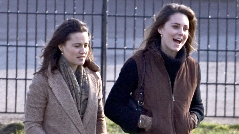 Pippa and Kate Middleton walking outside