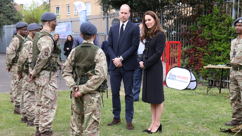 Kate Middleton and prince William speaking to cadets