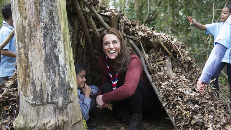 Kate Middleton in a tree fort laughing