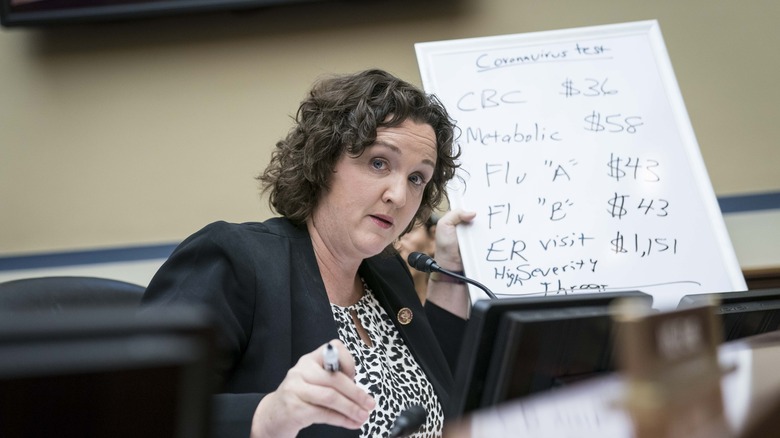 Katie Porter holding white board