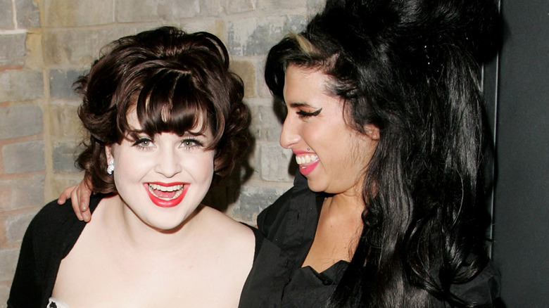 Kelly Osbourne and Amy Winehouse laughing at an event in 2007