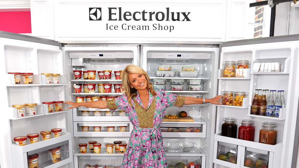 Kelly Ripa standing in front of a fridge