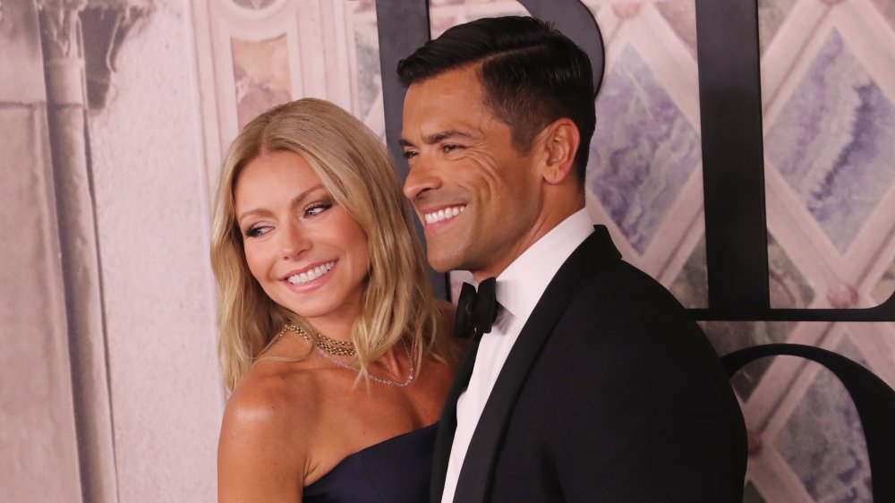 Kelly Ripa and Mark Consuelos looking to the side