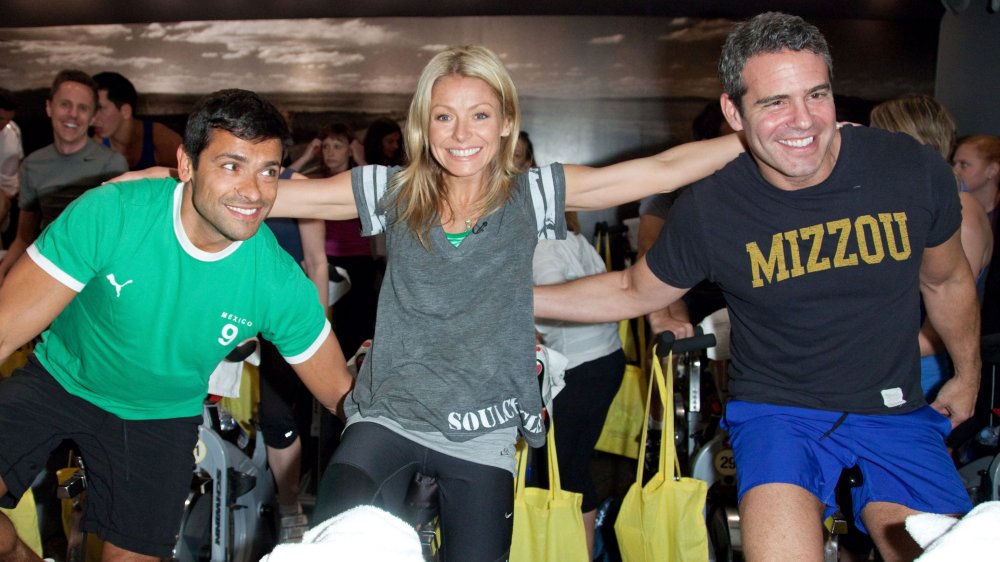 Kelly Ripa, Mark Consuelos, and a friend on spin bikes