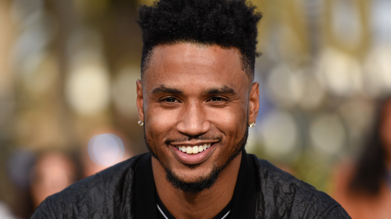 Trey Songz grinning at an event