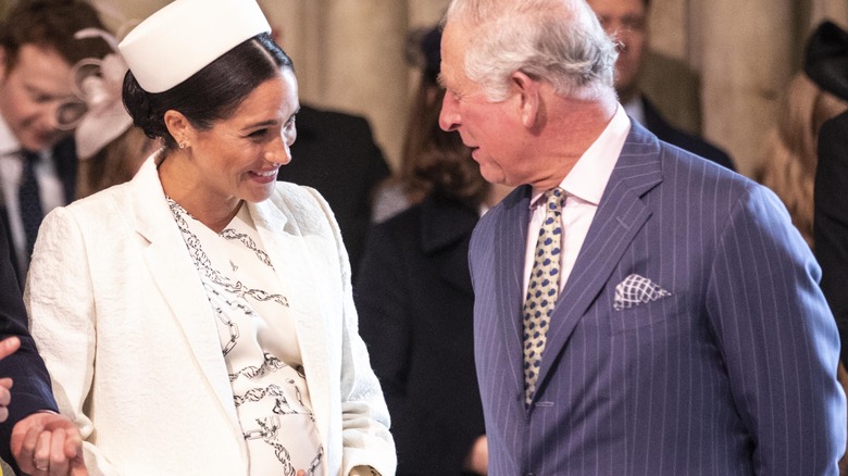 King Charles talking to pregnant Meghan Markle