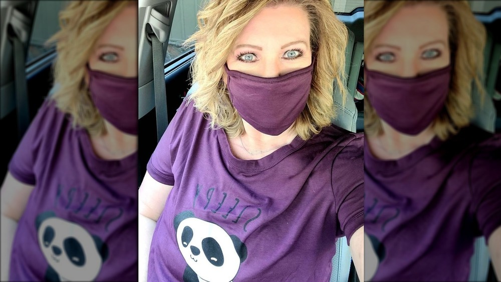 Meri Brown wearing a purple shirt and mask