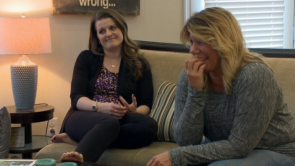 Meri and Robyn sitting on a couch together