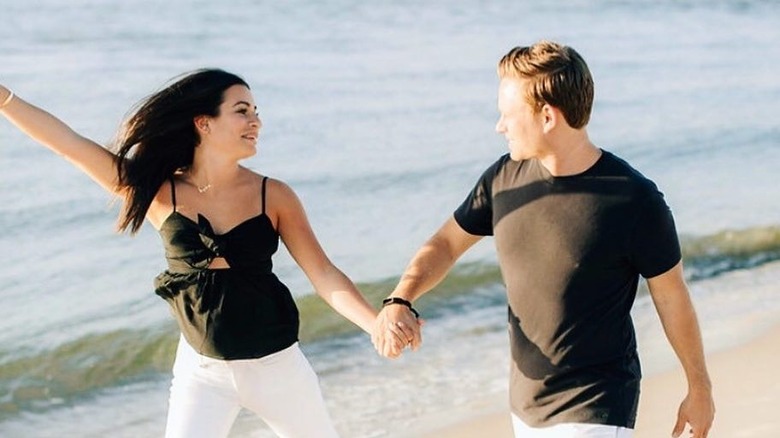 Lea Michele and Zandy Reich walking on a beach