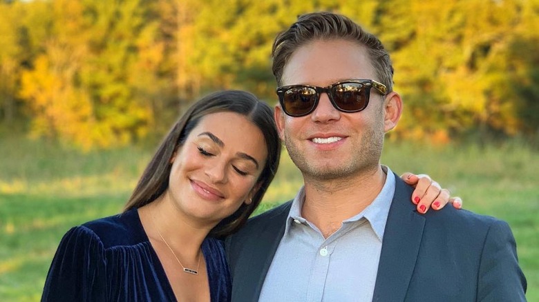 Lea Michele and Zandy Reich in front of yellow leaves