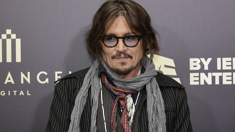 Johnny Depp wearing sunglasses on the red carpet