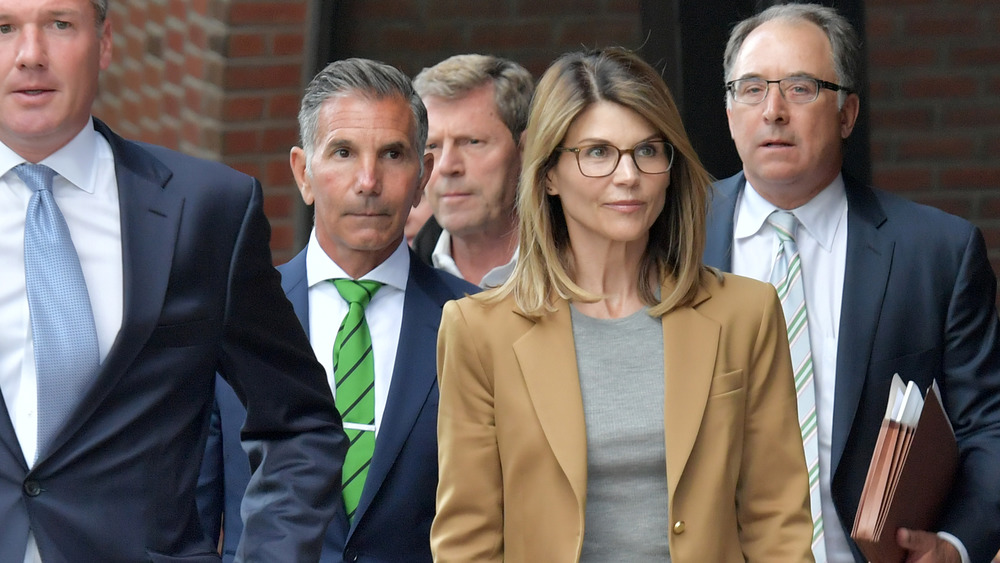 Lori Loughlin and Mossimo Giannulli leaving court with lawyers