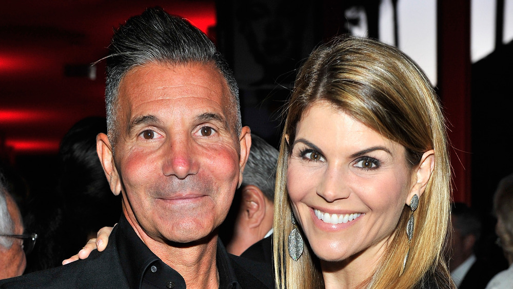 Lori Loughlin and Mossimo Giannulli at a cocktail party