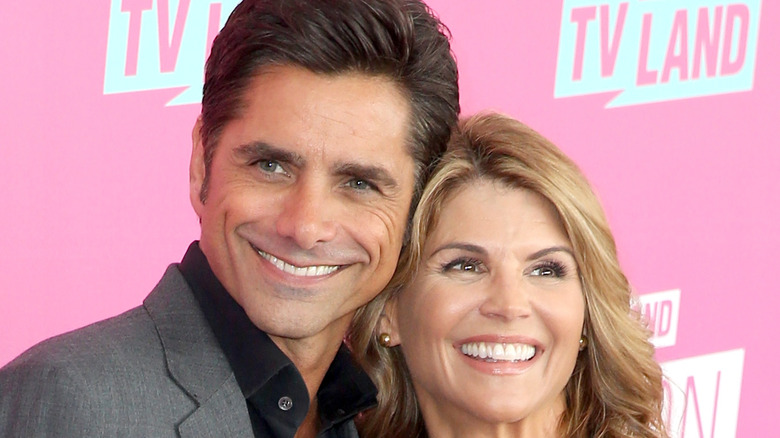 Lori Loughlin and John Stamos smile together on red carpet