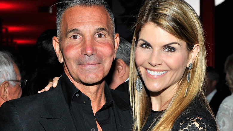 Lori Loughlin and Mossimo Giannulli smile at event