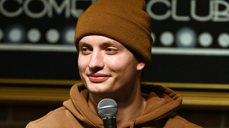 Matt Rife performing holding mic