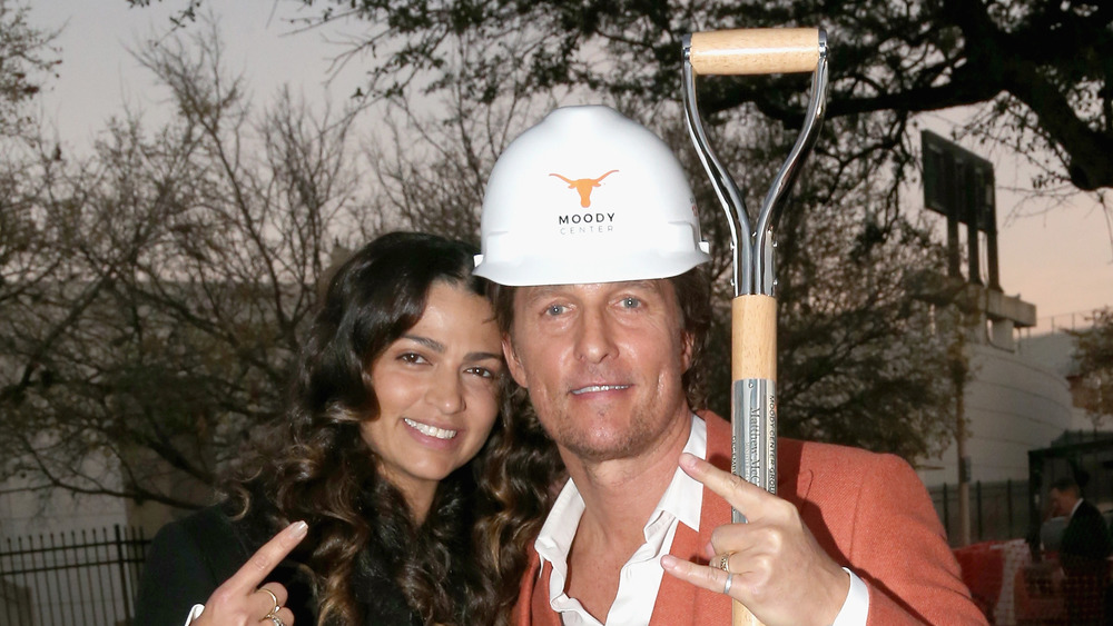 Matthew McConaughey and Camila Alves with a shovel