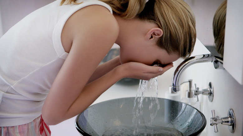 Woman washing her face