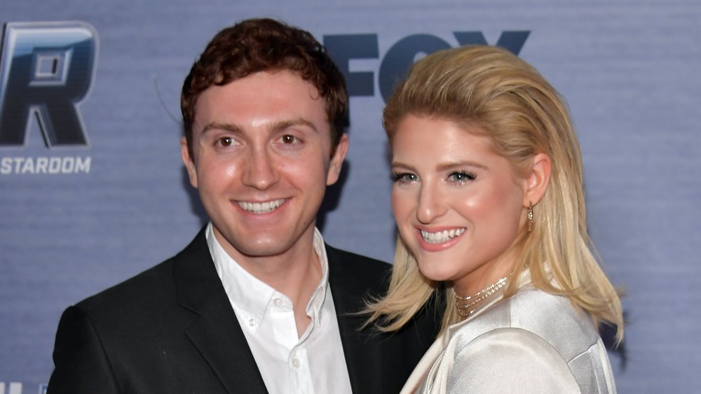 Meghan Trainor and Daryl Sabara smiling on the red carpet