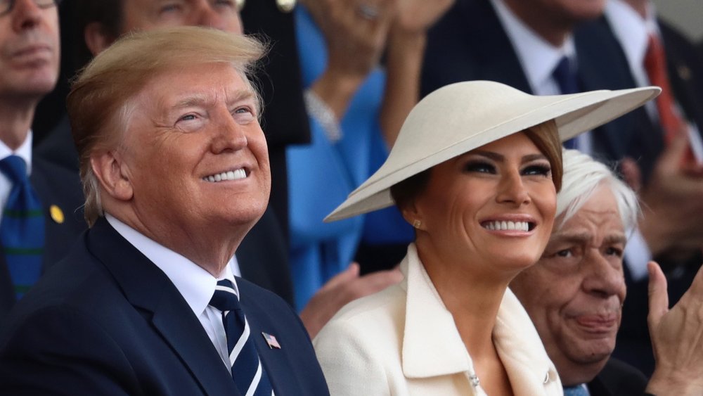 Donald Trump and Melania Trump looking up smiling