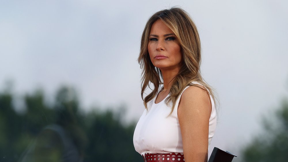 Melania Trump outside looking into the distance