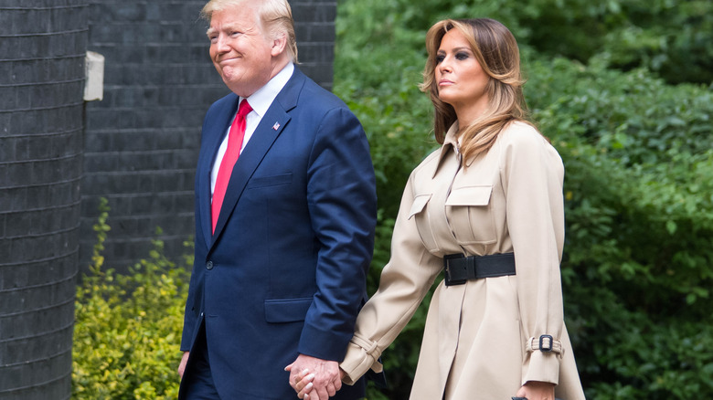 Donald and Melania Trump walking outside