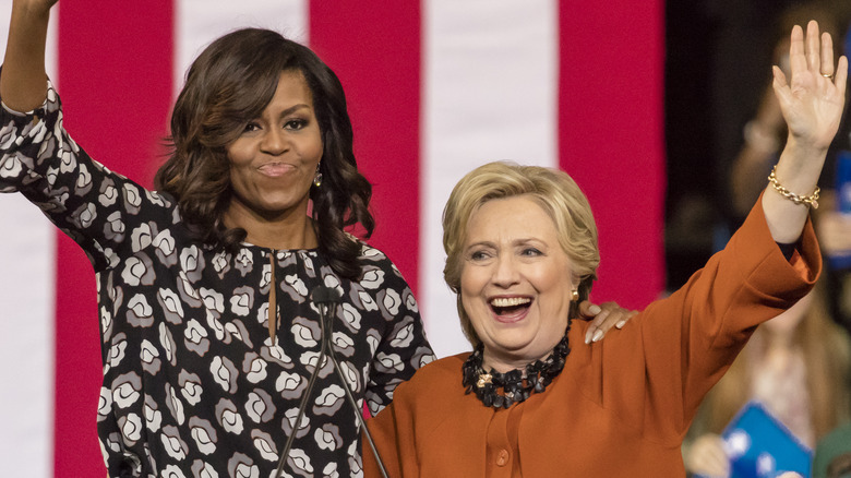 Michelle Obama and Hillary Clinton waving