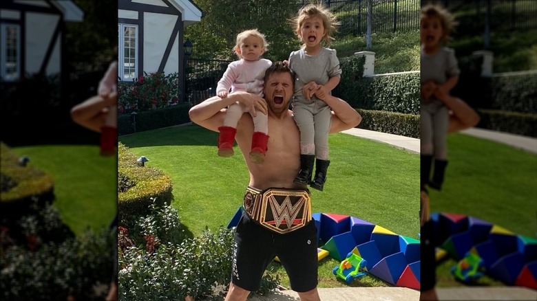 Mike Mizanin holding his daughters