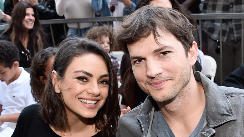 Mila Kunis and Ashlton Kutcher smile for the camera.