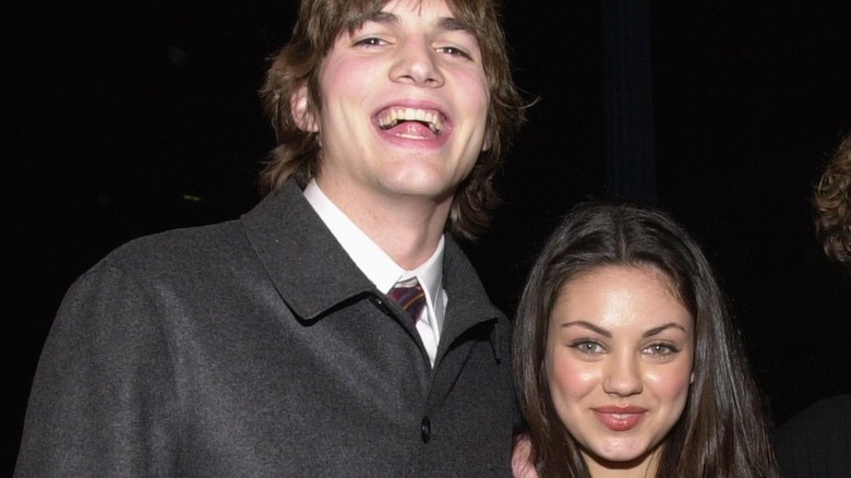 Younger Mila Kunis and Ashton Kutcher posing