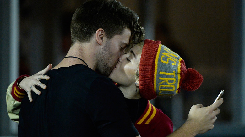 Miley Cyrus and Patrick Schwarzenegger kissing in 2014