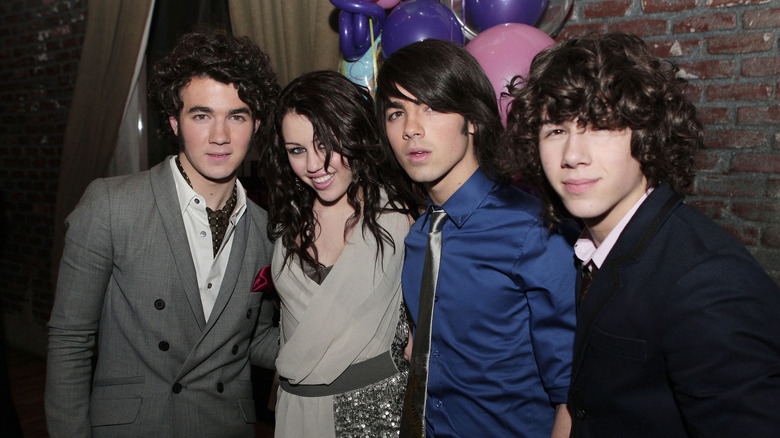 The Jonas brothers and Miley Cyrus in 2008