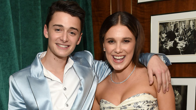 Noah Schnapp and Millie Bobby Brown pose with their arms around each other