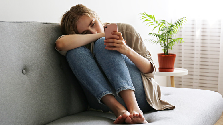 woman staring at the phone