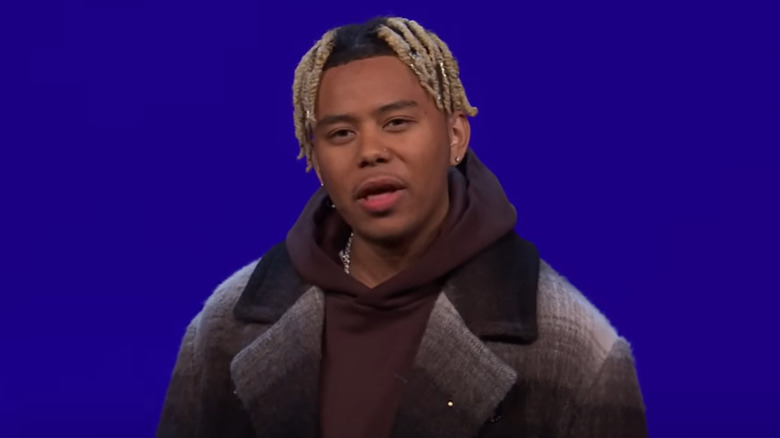 Cordae in front of blue background