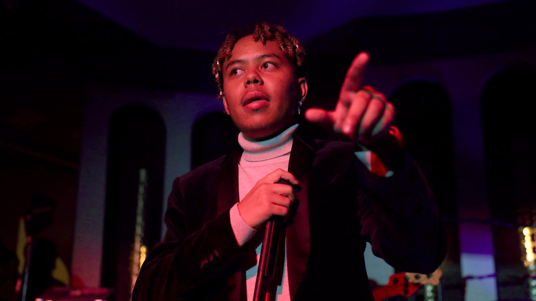 Cordae performing at a party