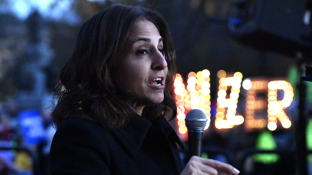 Neera Tanden profile, speaking into a mic outside