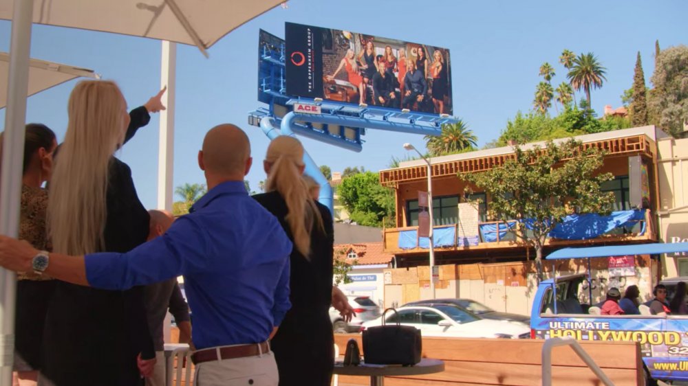 The cast of Selling Sunset looking at a billboard