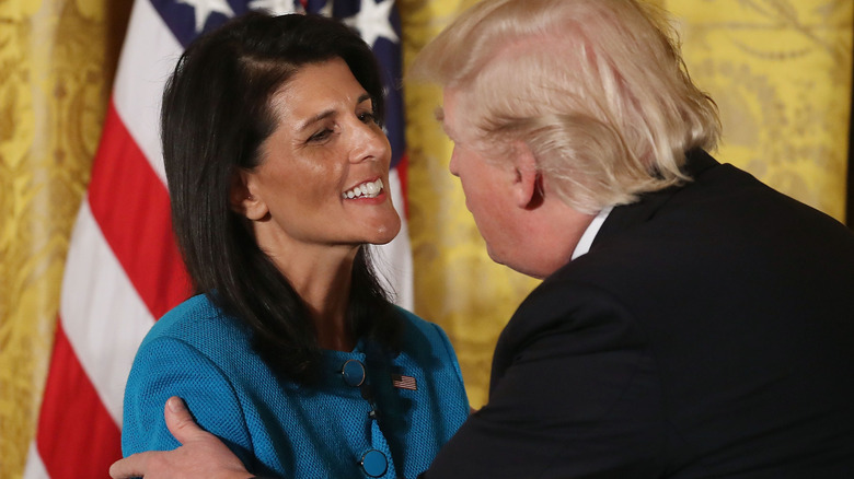 Nikki Haley smiling at Donald Trump