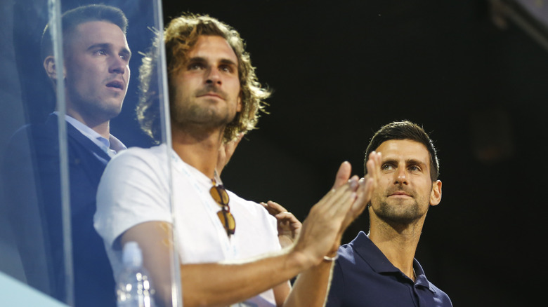 Novak, Marko and Djordje Djokovic watching a match