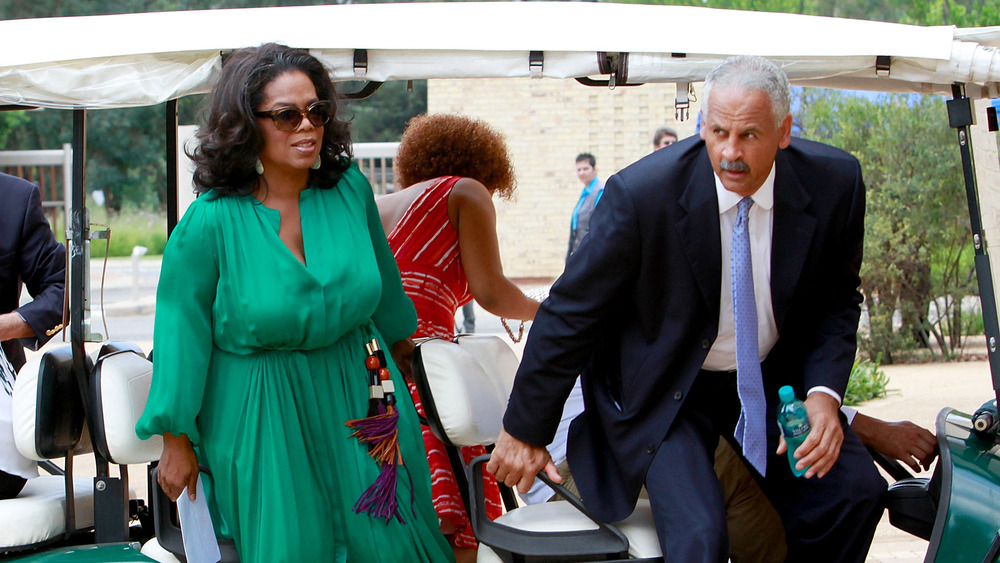 Oprah, Stedman exiting a golf cart