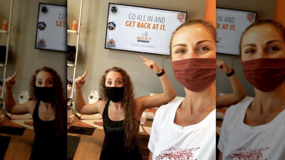 Orangetheory Fitness participants works out in mask