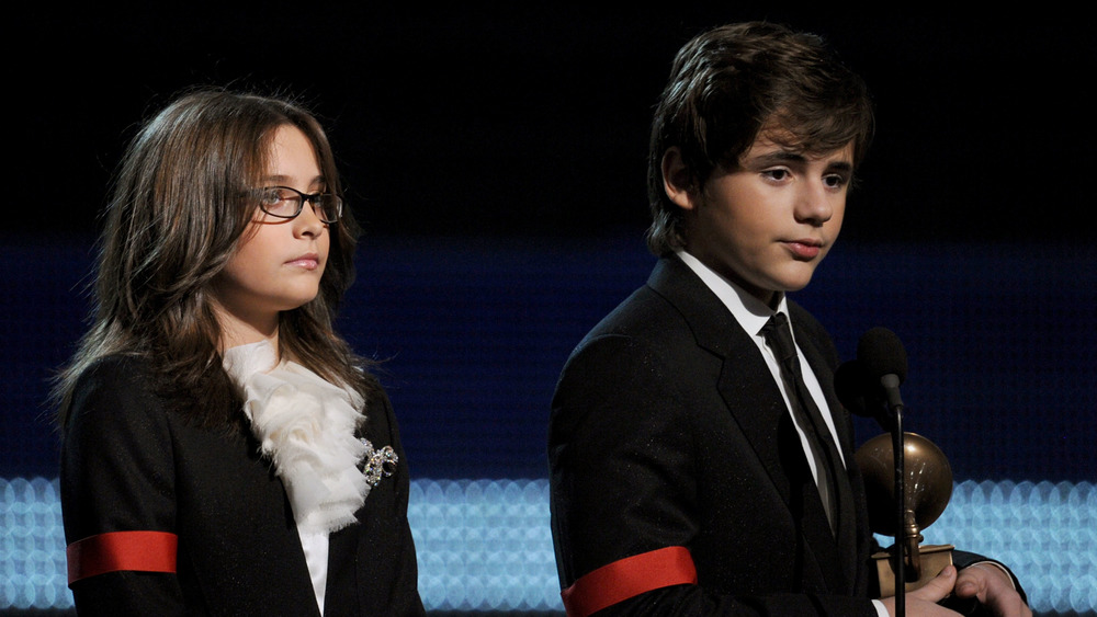 Paris and Prince Jackson wearing red armbands