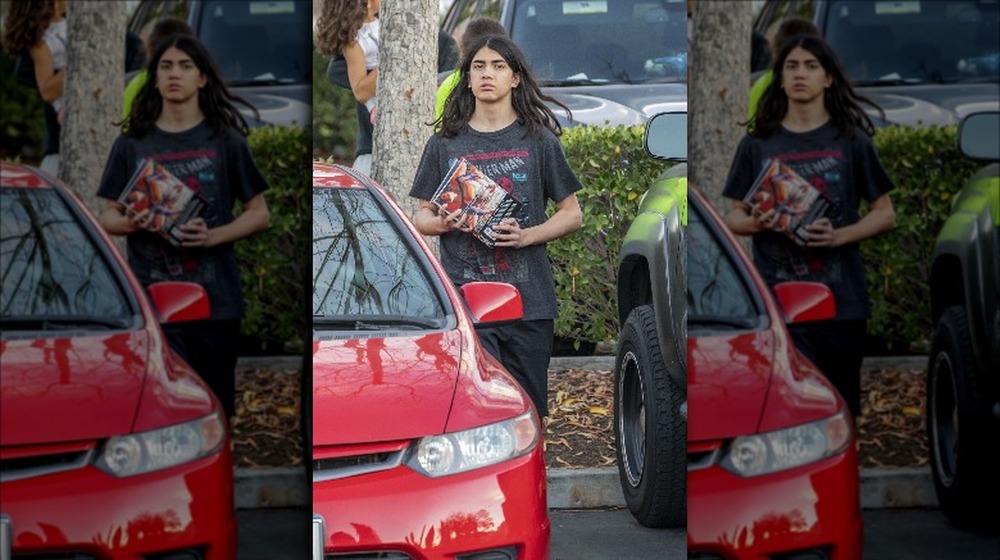 Bigi Jackson next to a red car