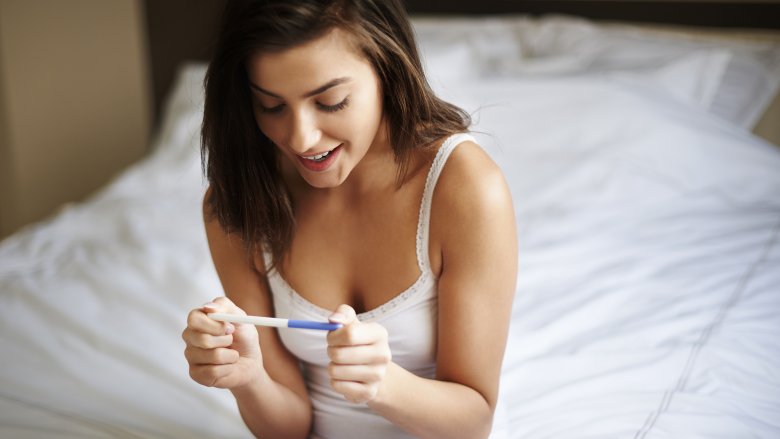 Woman with positive pregnancy test